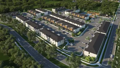 an aerial view of a building with a parking lot at 3BR Home w Game Room Near Disney in Kissimmee