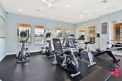 a gym with several treadmills and cardio machines at Luxury Condo Near Disney and Resort Access in Kissimmee