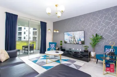 a living room with a couch and a table at Vibrant Family Condo -10 Min From Disney in Kissimmee