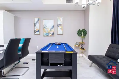 a living room with a pool table and a couch at Vibrant Family Condo -10 Min From Disney in Kissimmee