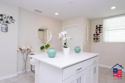 a bathroom with a white counter with vases on it at Condo near Disney with Resort in Kissimmee