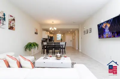 a living room with a white couch and a table at Resort Condo near Disney in Kissimmee