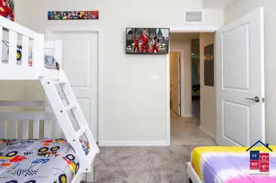 a bedroom with a bunk bed and a ladder at Resort Condo near Disney in Kissimmee