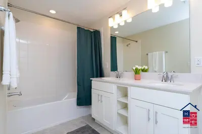a bathroom with two sinks and a tub and a shower at Resort Condo near Disney in Kissimmee