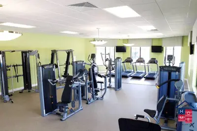a gym with several tread machines in a room at Resort Condo near Disney in Kissimmee