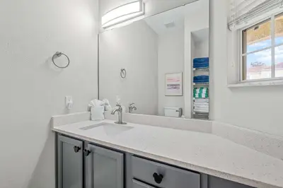 a bathroom with a sink and a mirror at Elegant Townhome with Water View in Kissimmee