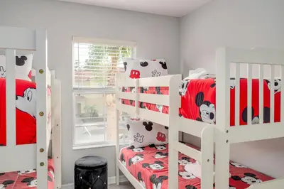 a bedroom with two bunk beds and a window at Elegant Townhome with Water View in Kissimmee