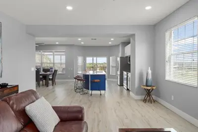 a living room with a couch and a kitchen at Windsor Hills View in Orlando