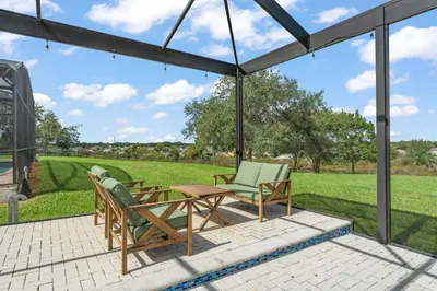 a patio with two chairs and a table at Windsor Hills View in Orlando