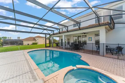 a patio with a pool and a house at Windsor Hills View in Orlando