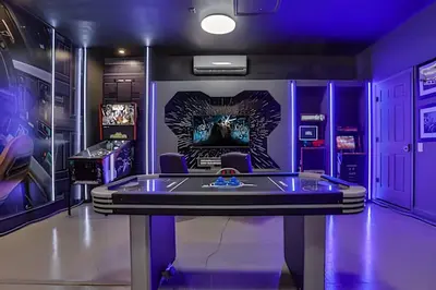 a purple room with a table and a fireplace at Luxo 5Q Windsor Hills c/ Piscina e Game Room in Orlando