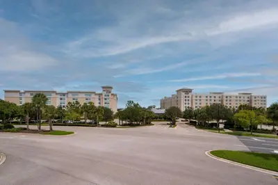 an empty street in front of a large building at TownePlace Suites Orlando at FLAMINGO CROSSINGS Town Center, Western Entrance in Orlando
