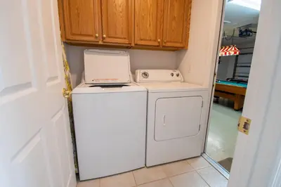 a washer and dryer sitting on top of a refrigerator at Free pool-spa heat - Near Disney - Nature view in Orlando