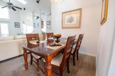 a dining room with a wooden table and chairs at Free pool-spa heat - Near Disney - Nature view in Orlando
