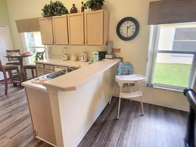 a kitchen with a counter and a clock on the wall at Rocco's Retreat in Orlando