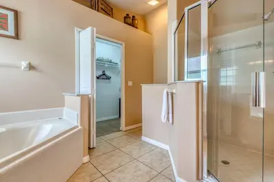 a bathroom with a shower and a bath tub at Safari Lodge in Orlando