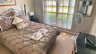 a bedroom with a bed with two towels on it at Minnie's Marvel in Kissimmee