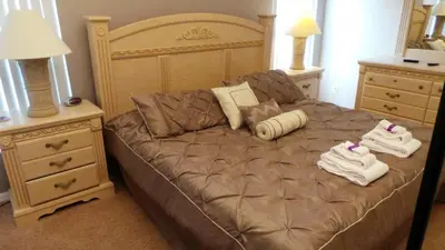 a bedroom with a bed with towels on it at Minnie's Marvel in Kissimmee