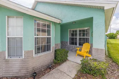 a yellow chair sitting on the porch of a house at The Boat House in Orlando