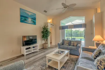 a living room with a couch and a tv at The Boat House in Orlando
