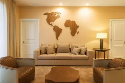 a living room with a couch and a map on the wall at Casa Luxo 4 Suítes no Magic Village in Kissimmee
