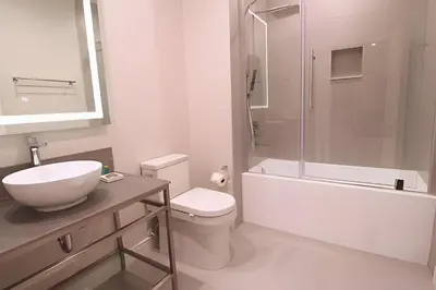 a bathroom with a sink and a toilet and a shower at Casa Luxo 4 Suítes no Magic Village in Kissimmee