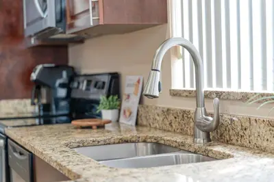 a kitchen counter with a sink in a kitchen at Lakefront Home with Game Room and Views in Kissimmee