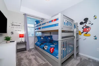 a bedroom with a bunk bed and a mickey mouse bedroom at Condo in the Heart of Orlando - 10 Min from Disney in Kissimmee