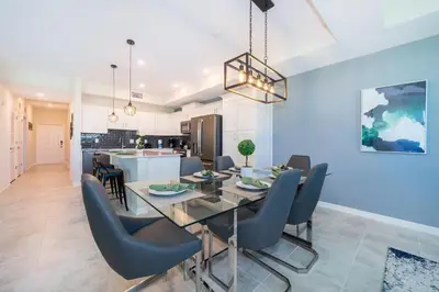 a dining room and kitchen with a dining table and chairs at Condo in the Heart of Orlando - 10 Min from Disney in Kissimmee