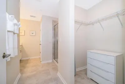 a bathroom with a white dresser and a shower at Condo in the Heart of Orlando - 10 Min from Disney in Kissimmee