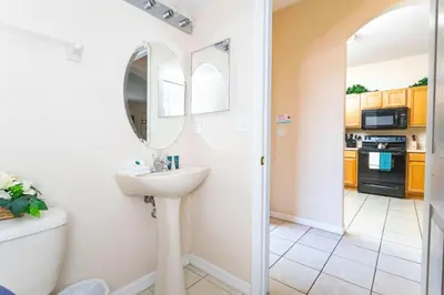 a bathroom with a sink and a mirror at Central House Near Disney in Orlando