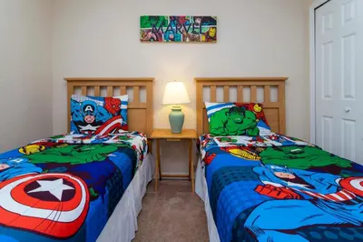 a bedroom with two beds with superheroes at Central House Near Disney in Orlando