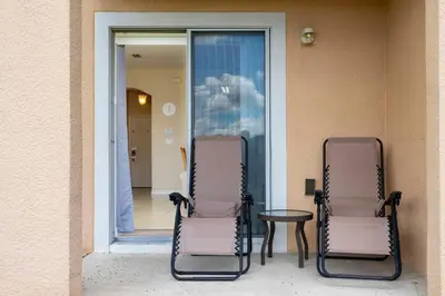 two chairs and a table in front of a window at Central House Near Disney in Orlando