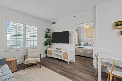 a living room with a bed and a television at King suite near Epic & Universal, free parking in Orlando