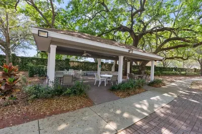 a pavilion with a table and chairs on a sidewalk at Casa 4Q c/ Piscina e Padaria – Perto da Disney in Kissimmee