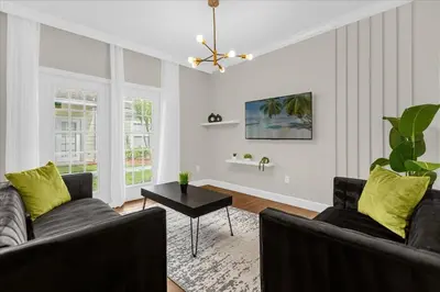 a living room with two couches and a table at Casa 4Q c/ Piscina e Padaria – Perto da Disney in Kissimmee