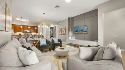 a living room with a couch and a dining room at Upstay Newly Renovated Family Retreat Home Near Epic Universe in Orlando
