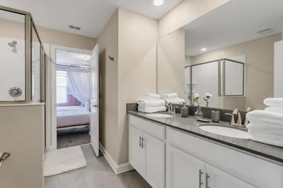 a bathroom with a sink and a mirror at Huge 9-Bedroom Luxury Villa Near Disney With Pool in Kissimmee
