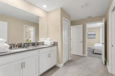 a bathroom with a sink and a mirror at Huge 9-Bedroom Luxury Villa Near Disney With Pool in Kissimmee
