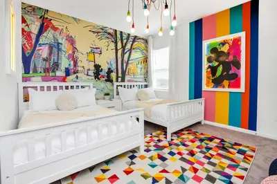 a bedroom with two beds and a colorful wall at Disney-Adjacent 15Bd15Ba Oasis With Private Pool in Kissimmee