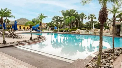 a swimming pool at a resort with palm trees at Family Resort Getaway w Pool & Patio near Disney in Kissimmee