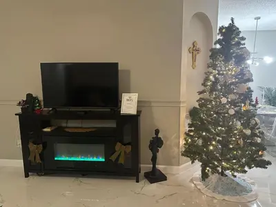 a living room with a christmas tree and a fireplace at Orlando Lakefront Pool Villa 25 min Disney & Univ in Orlando