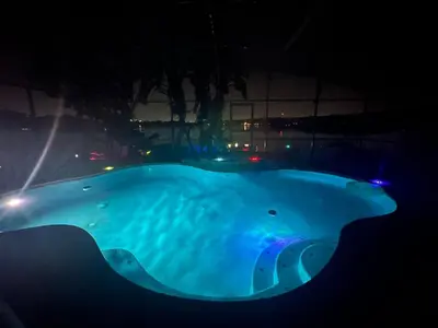 a large blue bath tub with lights in the dark at Orlando Lakefront Pool Villa 25 min Disney & Univ in Orlando