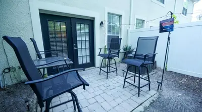 a group of chairs sitting on a patio at Stylish and cozy townhome! in Orlando