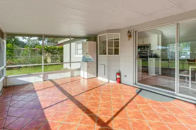 an empty house with a kitchen with a refrigerator at Gateway to Orlando Theme Parks! Home with Large Yard in Orlando