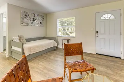 a bedroom with a bed and a chair and a window at Gateway to Orlando Theme Parks! Home with Large Yard in Orlando