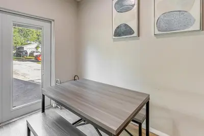 a wooden table in a room with a window at Townhome with Fenced Yard in Orlando Suburbs! in Orlando