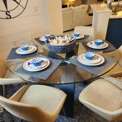 a glass table with chairs and a bowl of food on it at Mickeys Magical Escape in Orlando