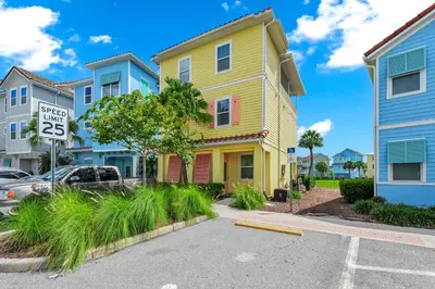 a yellow house with a speed limit sign in a street at A Parrot's Live For Me Cottage With Private Pool Near Disney With Margaritaville Resort & Island H20 Waterpark Access - 8028Sh in Orlando