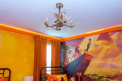 a room with a painting on the ceiling and a chandelier at Brand New 9 Bedroom Single Family Storey Lake 18ST in Kissimmee
